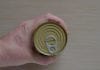 How to Open a Can Without a Can Opener Hand Of An Adult Man Holds A Can Of Canned Food. Closed Tin Can