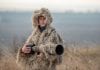 How to Make a Ghillie Suit Camouflage wildlife photographer in the ghillie suit working in the wild